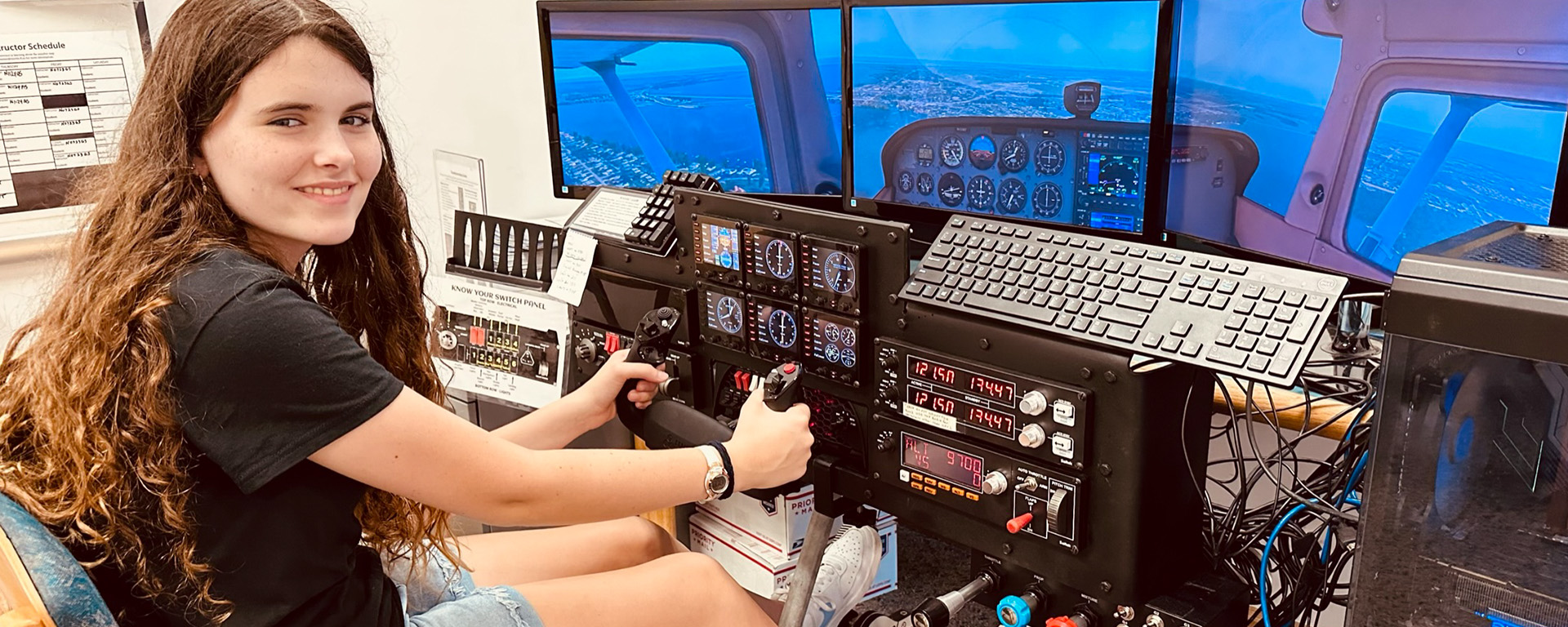 Teen girl smiling at Flight Simulator controllers