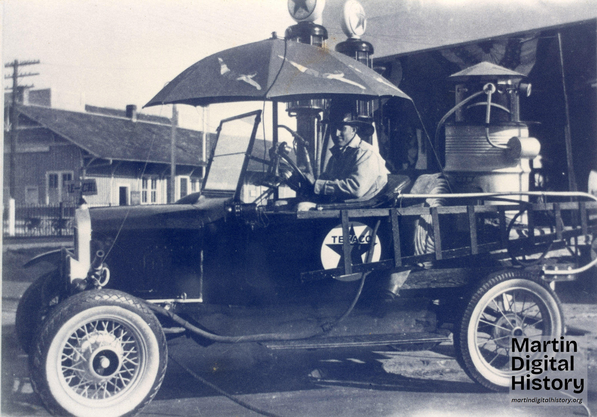 Sepia coloed photo of improvished fire truck from 1921